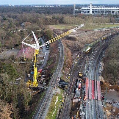 Hiflsbrücken werden mithilfe eines Krans eingebaut.